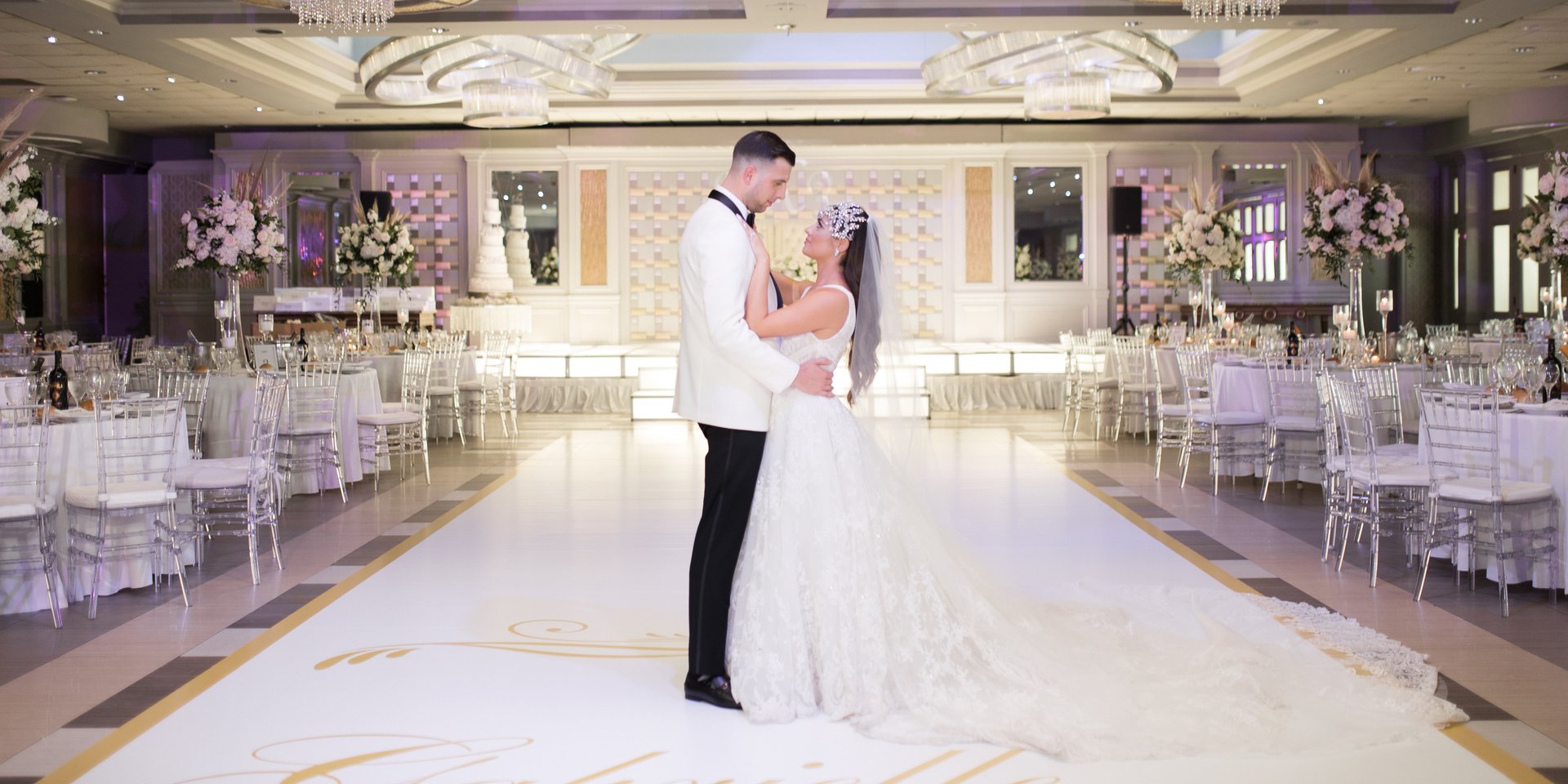A couple on the Encore Ballroom dance floor, tables set around them