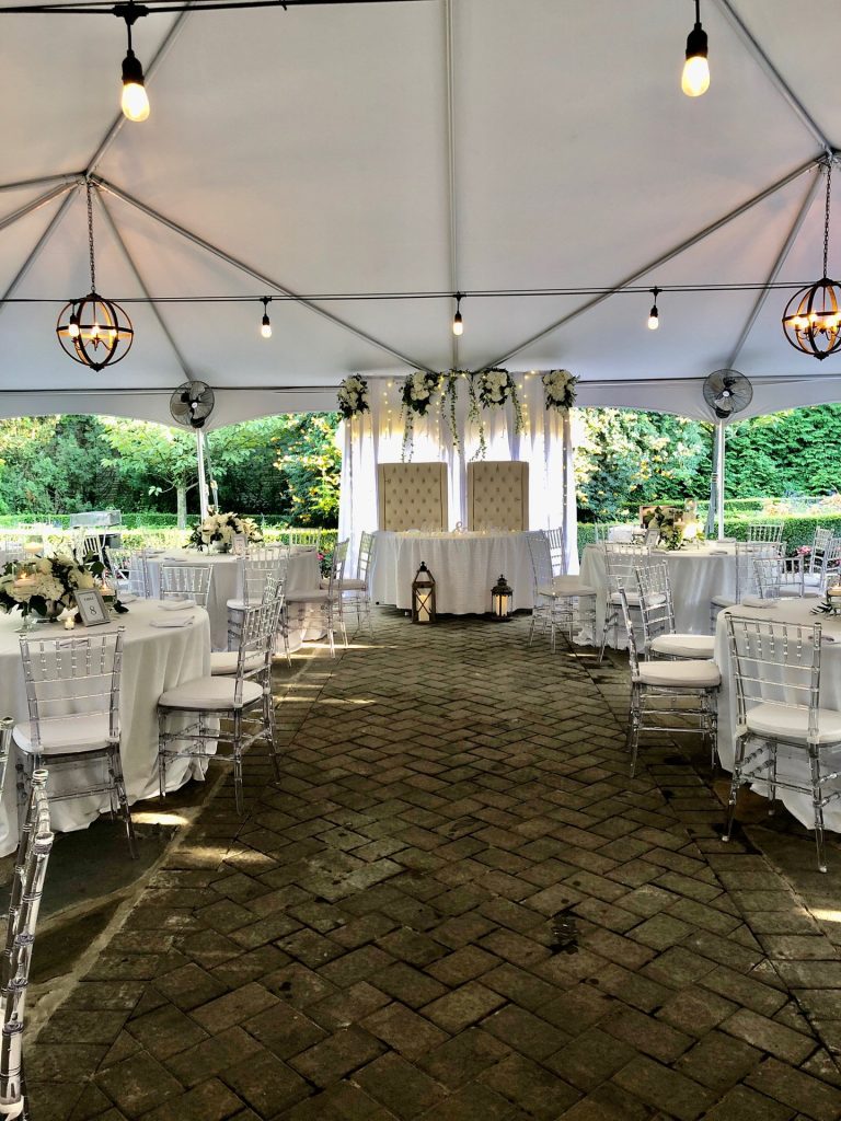 Reception tables under a white tent in Russo’s Garden