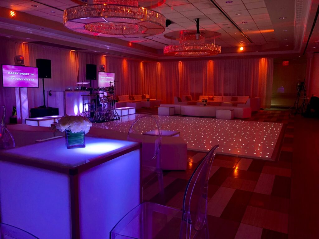 The Paragon set for a Sweet 16, with lit cube tables, lounge sofas and an LED dance floor