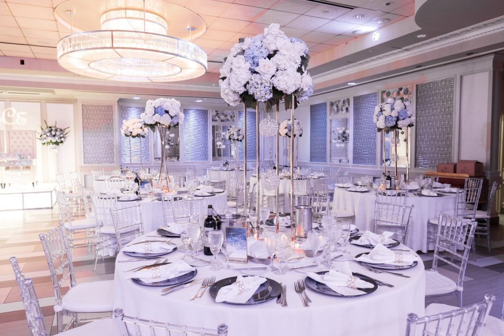 The Paragon set for dinner, with tall white floral centerpieces on every table