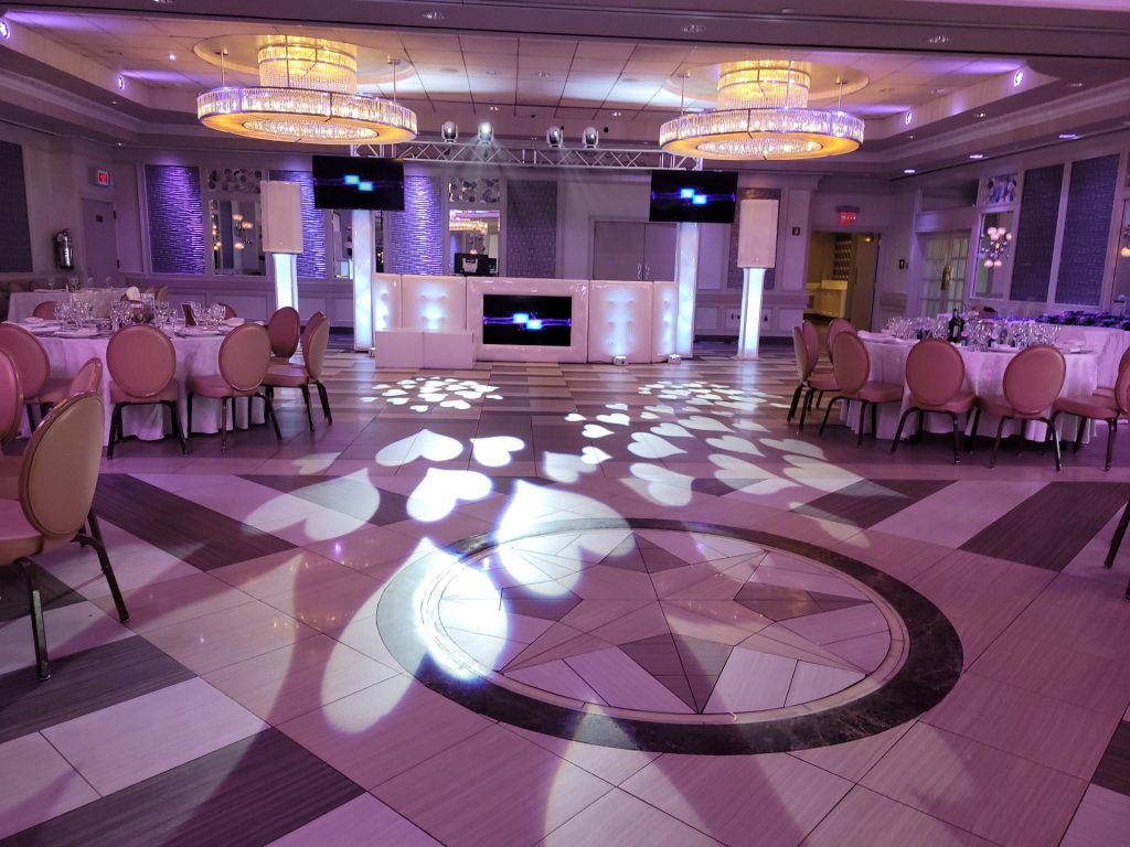The Paragon’s dance floor in patterned light, with a DJ booth and tables set around it