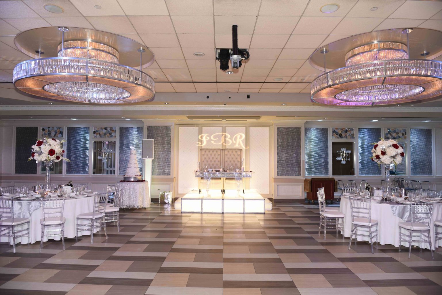 The Paragon set for a reception, with red and white roses on each table