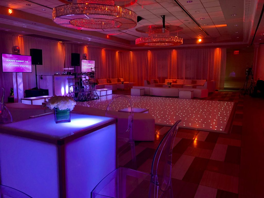 The Paragon set for a Sweet 16, with lit cube tables, lounge sofas and an LED dance floor