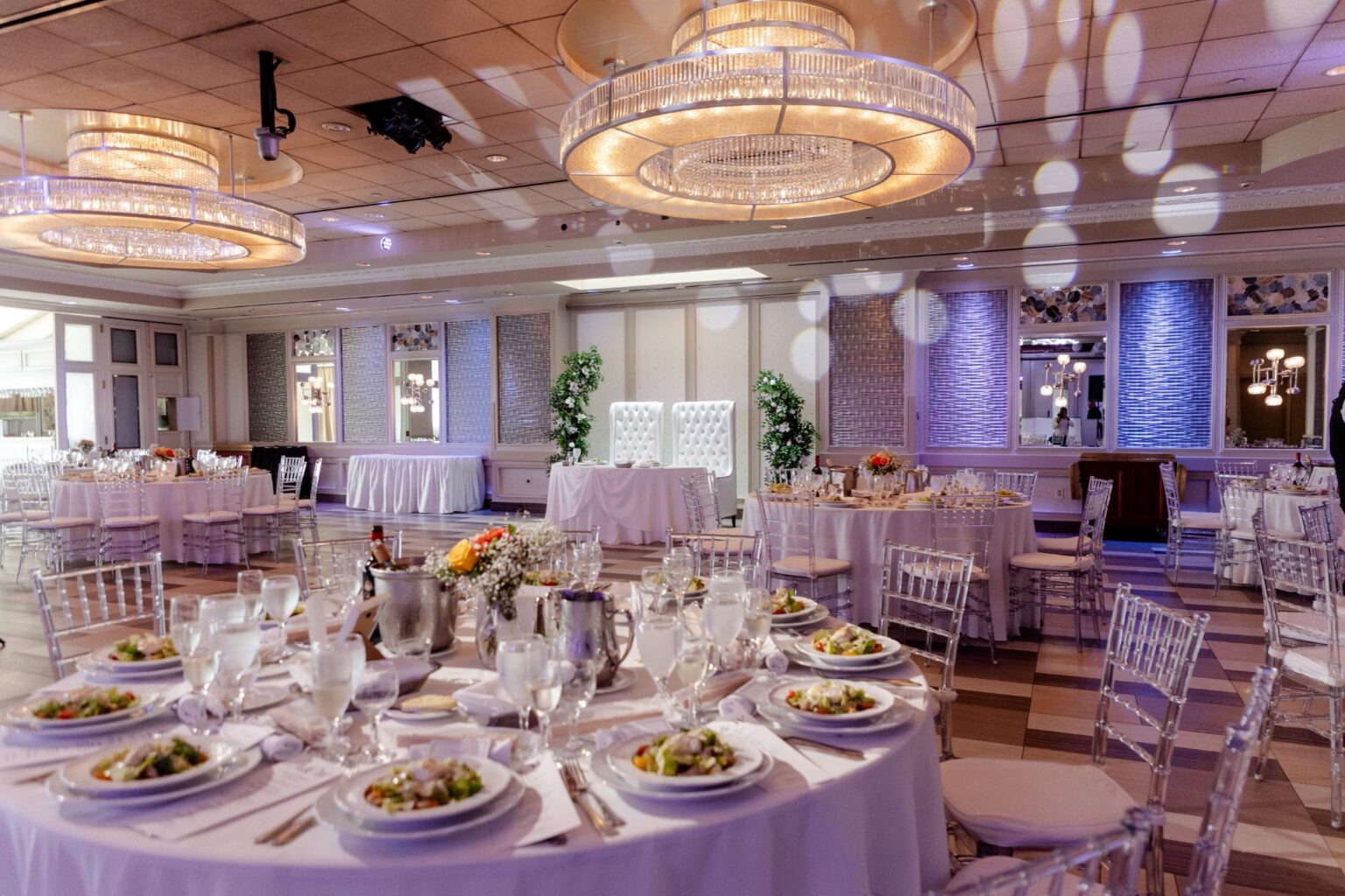 The Paragon set for dinner, salads at each place under drum chandeliers