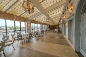 The Promenade, a skylit glass gallery with tables along its waterfront windows