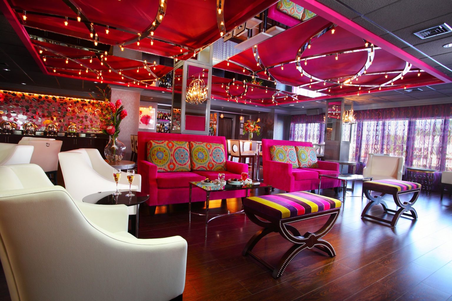 The Rose Lounge, with magenta sofas, white armchairs and the bar behind
