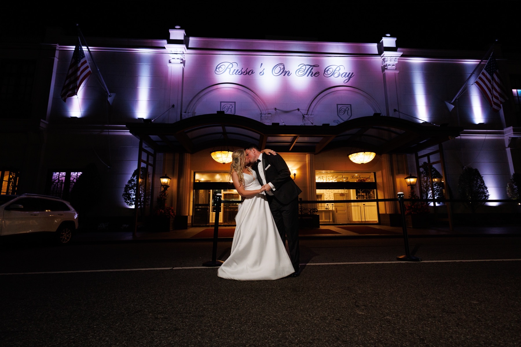 The facade of Russo’s On The Bay lit at night