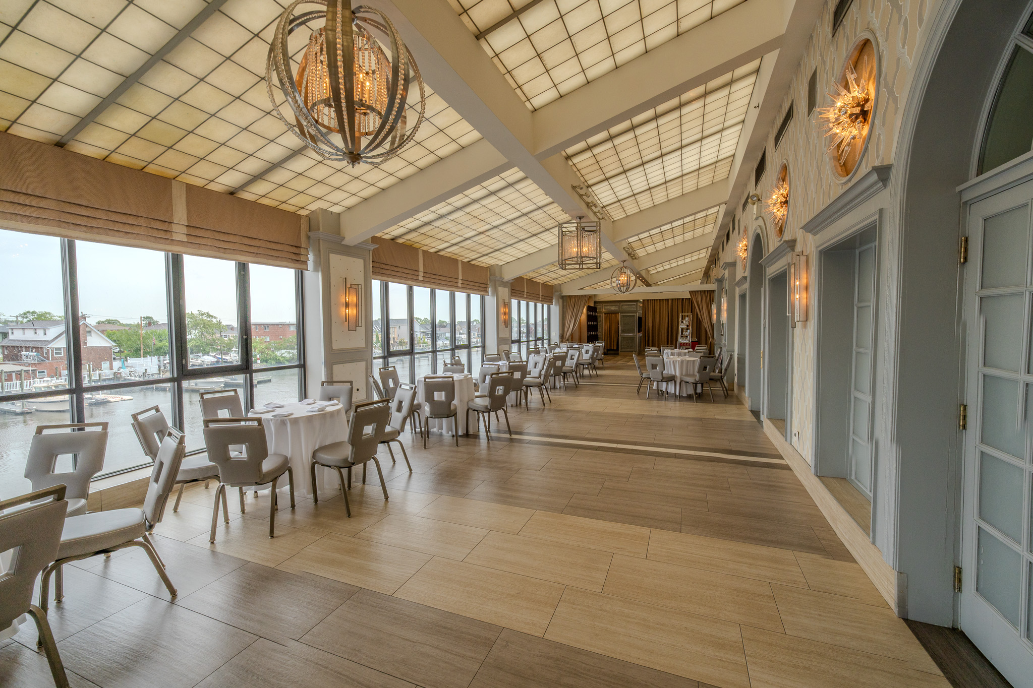 The Promenade, a skylit glass gallery with tables along its waterfront windows