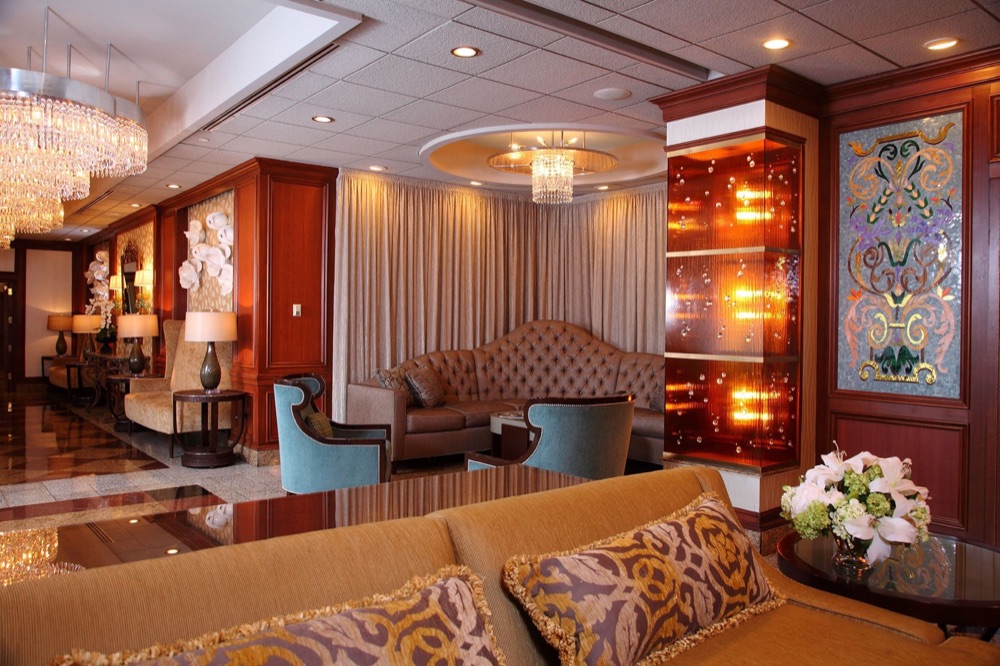 Vetro’s lounge, with sofas, crystal chandeliers and a colored glass panel